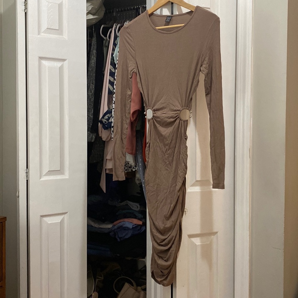 Brand new never worn cut out dress with ring details.